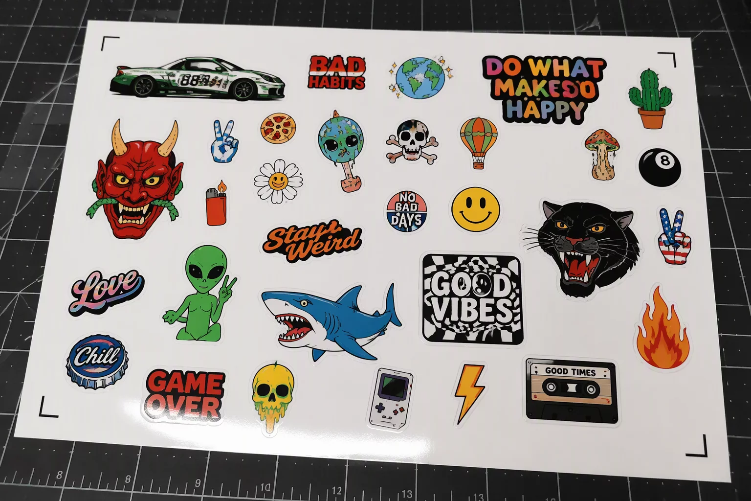 Printed sheet with registration marks and mixed-size stickers ready for cutting.